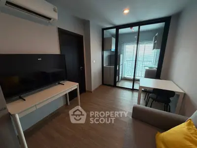 Modern living room with TV, air conditioning, and balcony view in a stylish apartment.