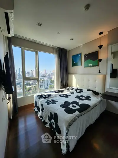 Modern bedroom with city view, large windows, and stylish decor in a high-rise apartment.
