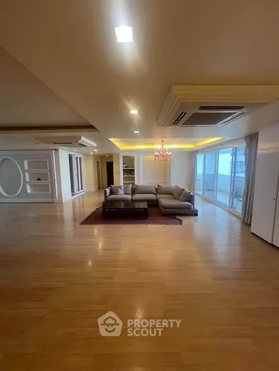 Spacious living room with elegant decor and large windows for natural light.