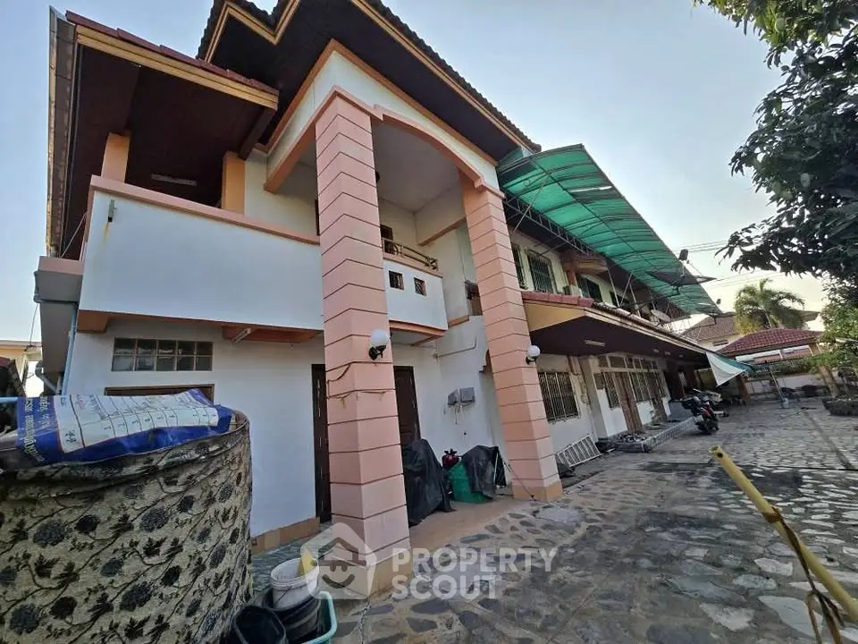 Charming two-story house with spacious courtyard and unique architectural design.