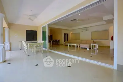 Spacious open living room with elegant dining area and modern decor.