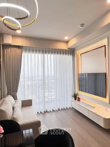 Modern living room with elegant lighting and large window view.