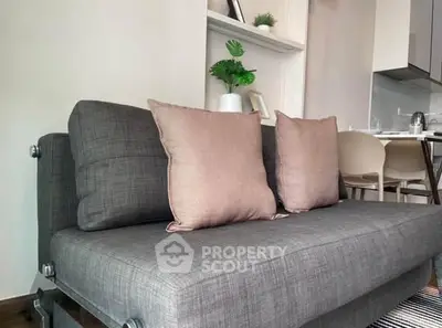 Modern living room with stylish gray sofa and cozy cushions