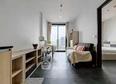 Modern apartment interior with sleek design and city view, featuring a cozy living area and workspace.