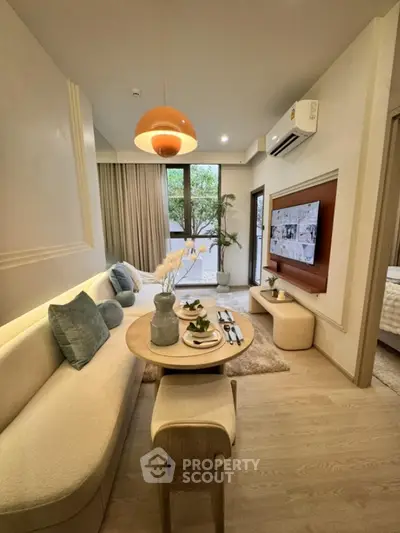 Modern living room with stylish decor and natural light, featuring cozy seating and elegant dining area.