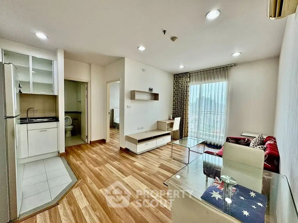 Modern living room with open kitchen and balcony view