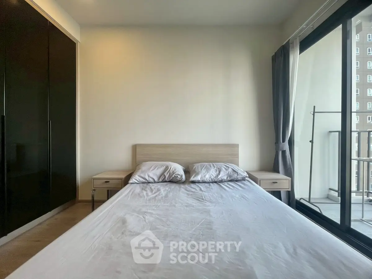 Modern bedroom with balcony access and sleek wardrobe design