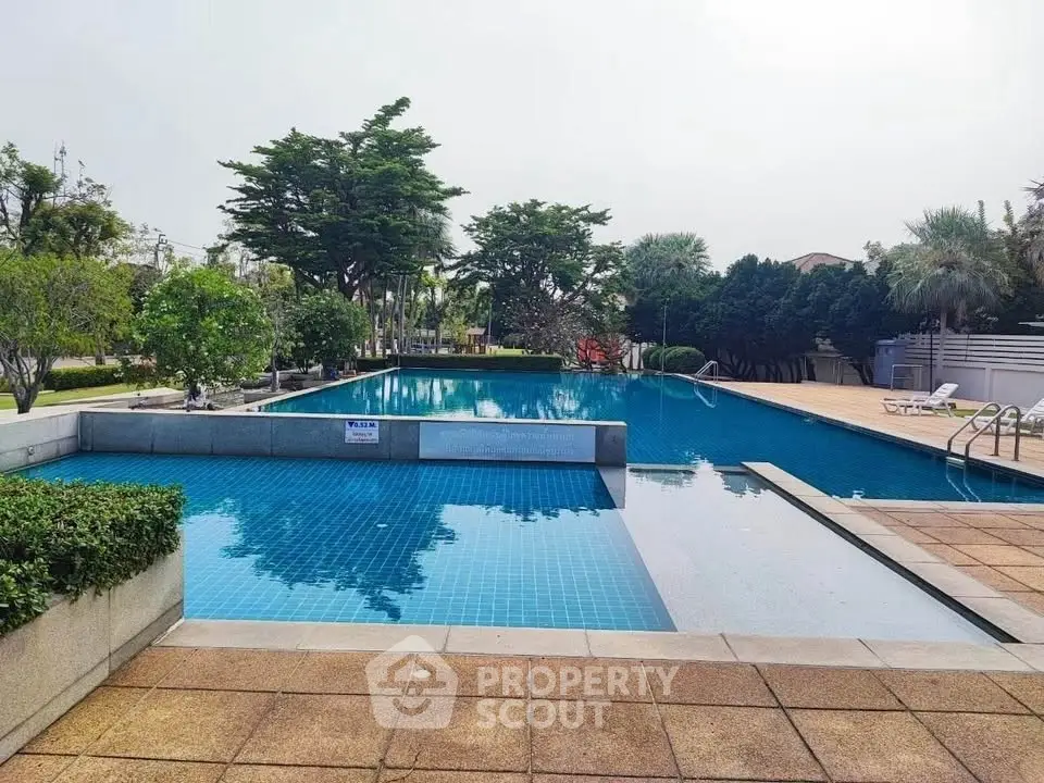 Luxurious outdoor swimming pool with lush greenery and serene ambiance
