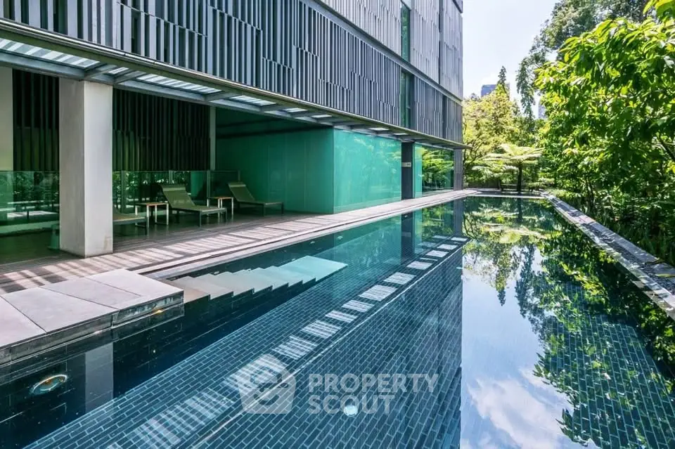 Luxurious modern apartment with stunning poolside view and lush greenery, perfect for relaxation and leisure.