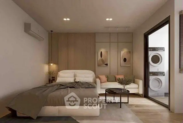Modern bedroom with cozy seating area and in-unit laundry, featuring stylish decor and warm lighting.