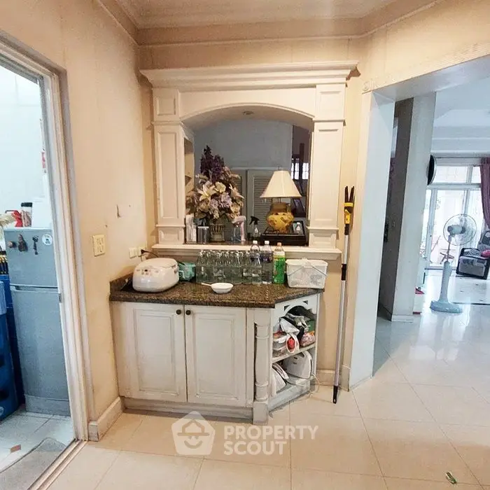 Charming kitchen corner with elegant cabinetry and decorative archway