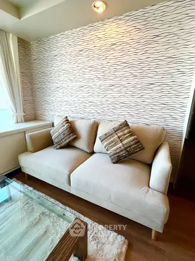 Stylish living room with modern sofa and elegant decor in a cozy apartment setting.