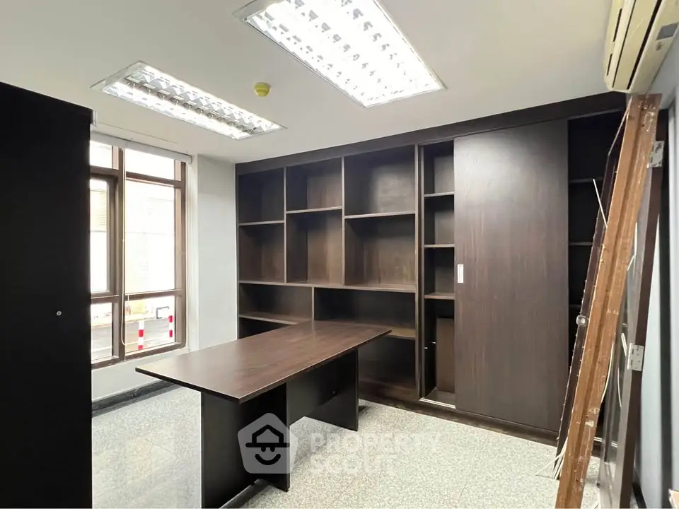 Modern study room with built-in shelving and large window