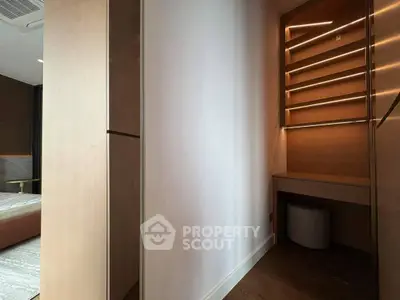 Modern bedroom with built-in shelving and cozy lighting, perfect for stylish living.