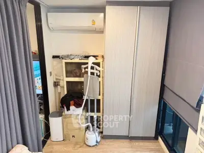 Compact bedroom with modern wardrobe and air conditioning unit, ideal for urban living.