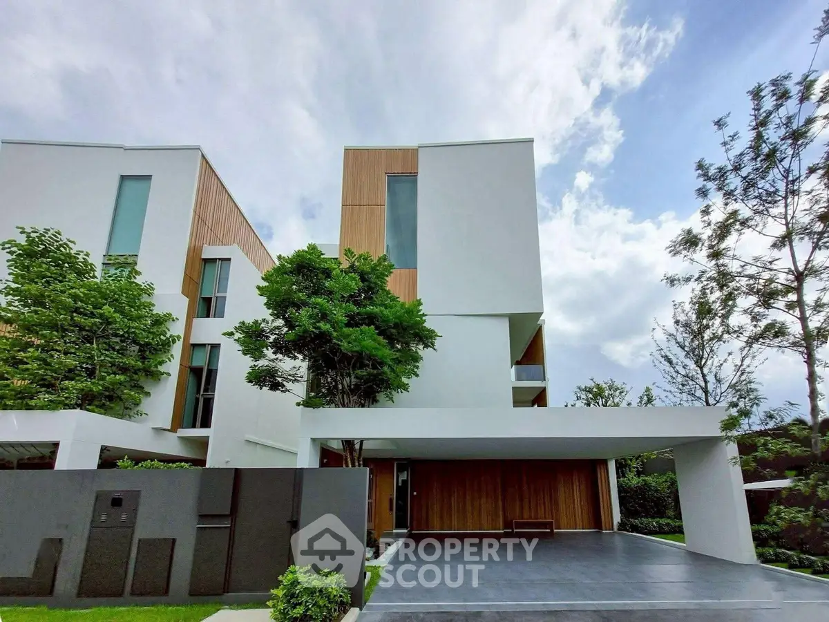 Modern architectural home with sleek design and lush greenery