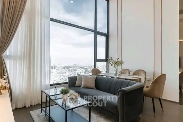 Luxurious high-rise living room with stunning city view and elegant furnishings.