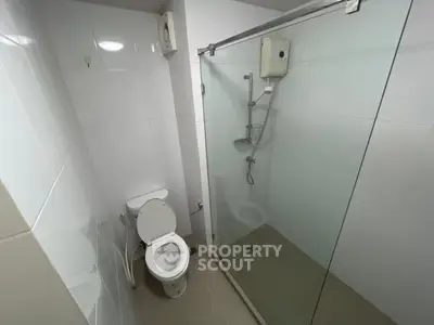 Modern bathroom with glass shower enclosure and white tiles