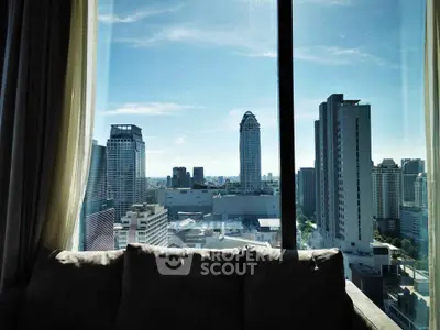 Stunning cityscape view from a high-rise apartment window, showcasing urban skyline and modern architecture.