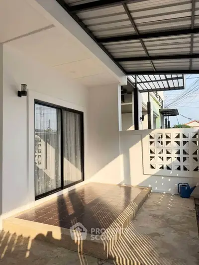 Modern patio with sliding glass doors and stylish roof design
