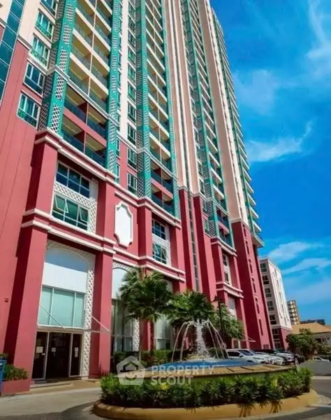 Stunning high-rise building with vibrant facade and elegant entrance fountain.