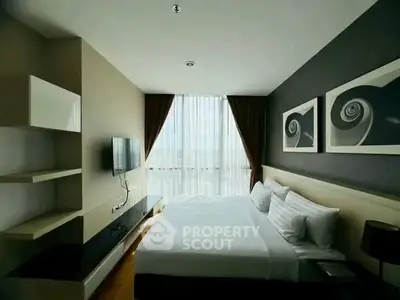 Modern bedroom with large window and stylish decor in a high-rise apartment.