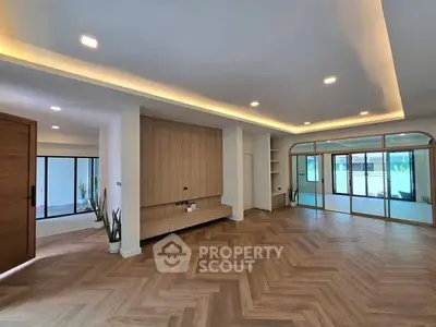 Spacious modern living room with elegant wooden flooring and large windows