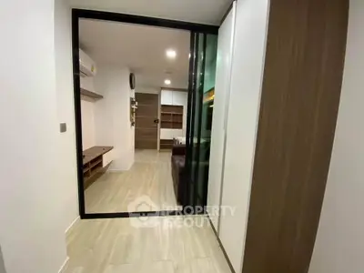 Modern apartment interior with sliding glass doors and wooden flooring