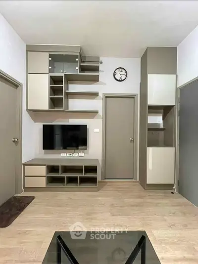 Modern living room with sleek storage and wall-mounted TV