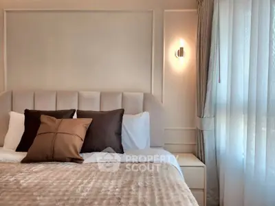 Luxurious bedroom with elegant decor and soft lighting, featuring plush bedding and stylish curtains.