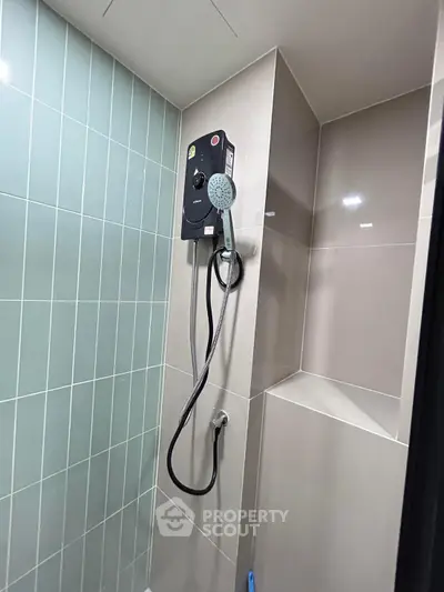 Modern bathroom shower with sleek tiles and advanced showerhead system.