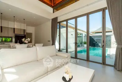 Luxurious living room with pool view and modern open kitchen layout