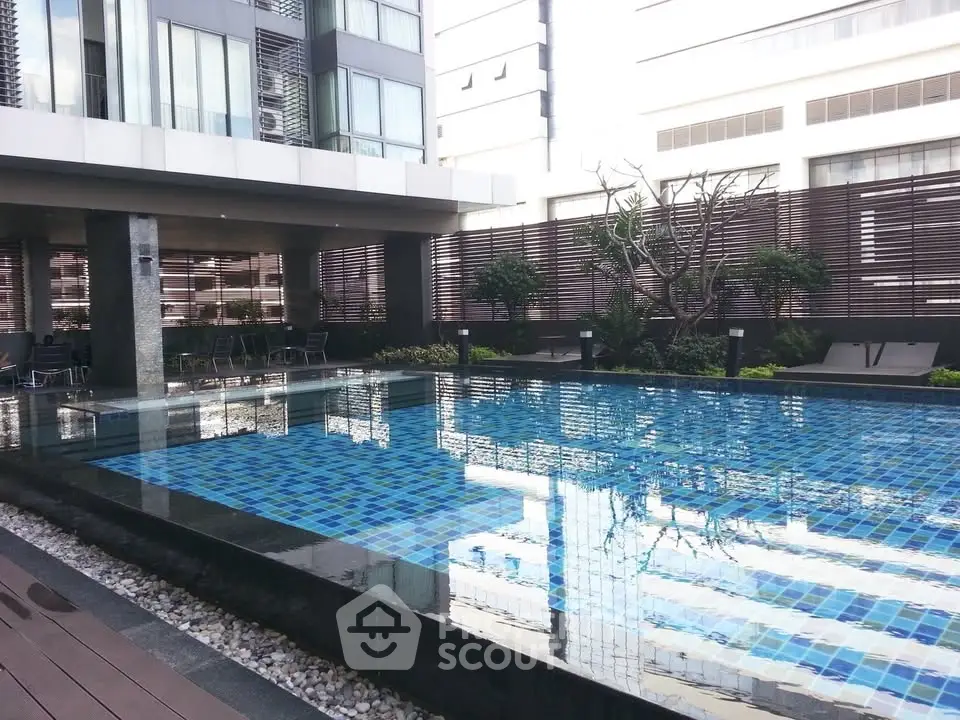 Luxurious modern apartment complex with stunning outdoor pool and stylish design.