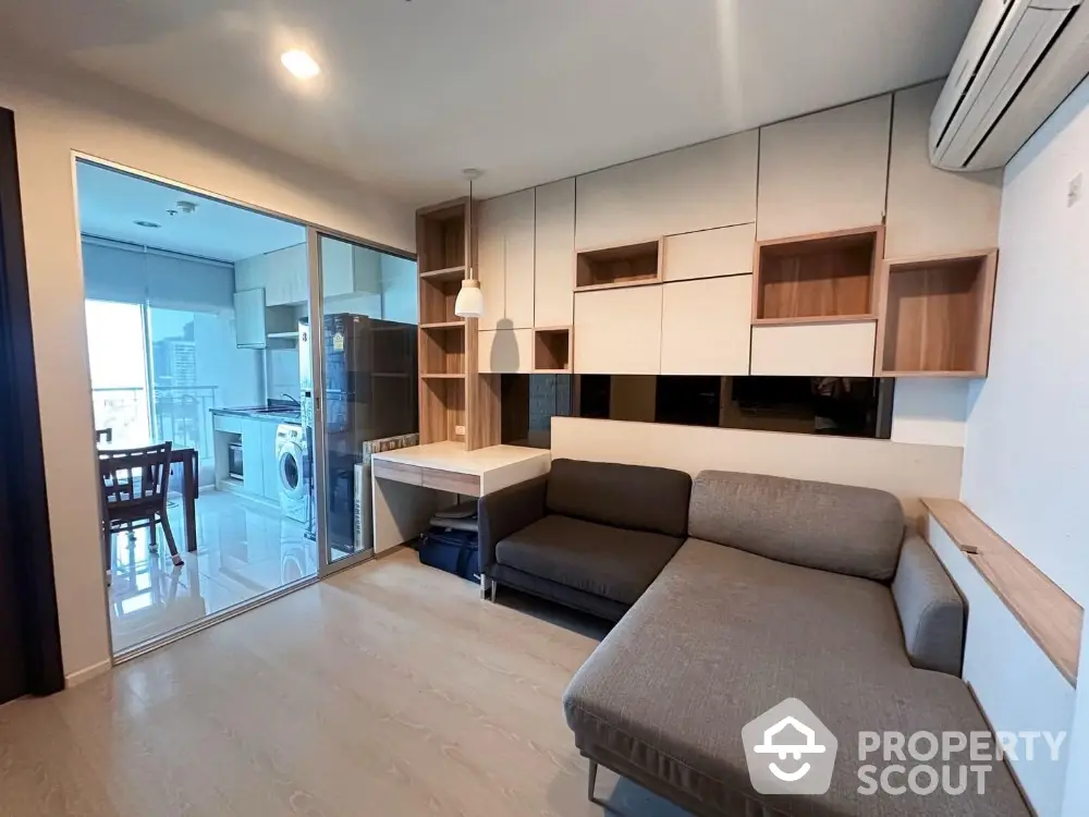 Modern living room with stylish furniture and open kitchen layout in a contemporary apartment.