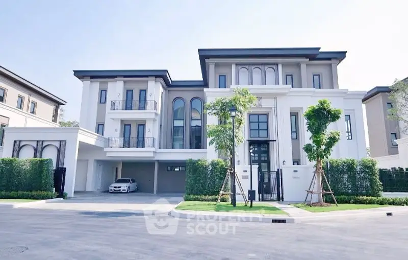 Luxurious modern three-story house with elegant facade and spacious driveway