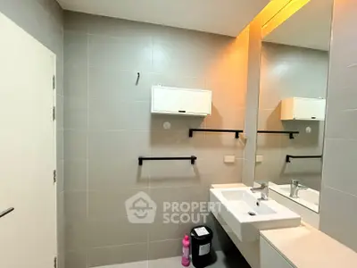 Modern bathroom with sleek fixtures and large mirror