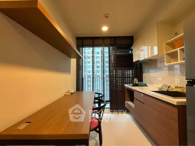 Modern kitchen with sleek wooden cabinetry and open layout in urban apartment