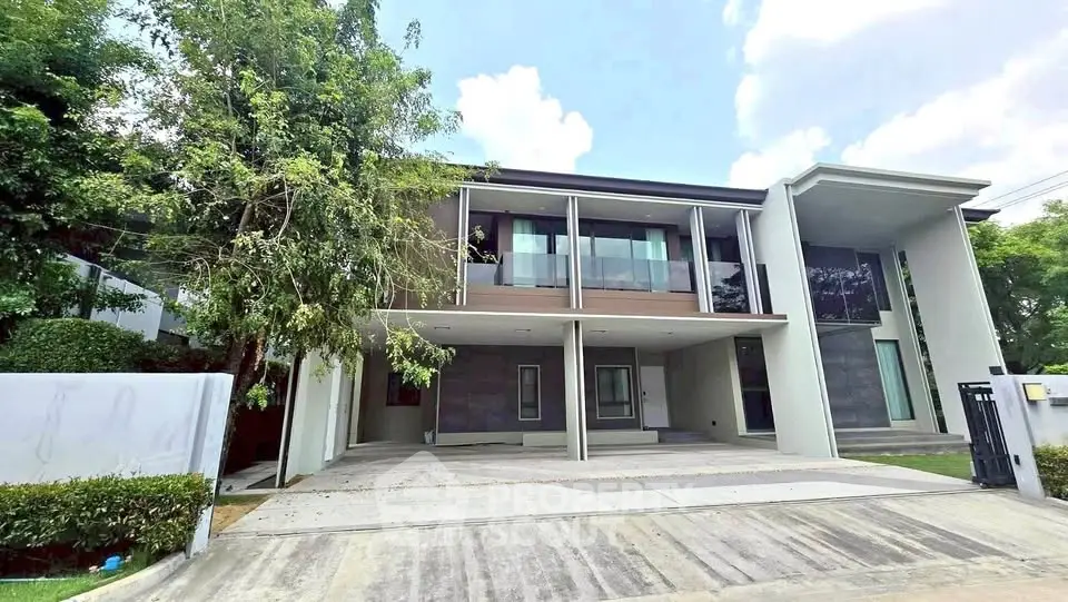 Modern two-story house with spacious driveway and lush greenery