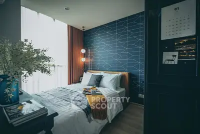 Stylish bedroom with modern decor and geometric accent wall, perfect for cozy living.