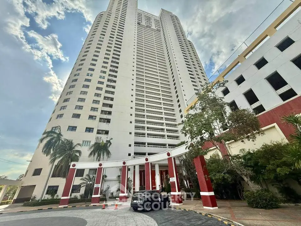 Stunning high-rise building with modern architecture and lush landscaping, perfect for urban living.