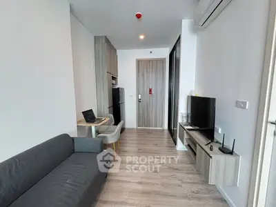 Modern living room with sleek furniture and open layout in a stylish apartment.