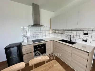 Modern kitchen with sleek cabinetry and built-in appliances in a stylish apartment.