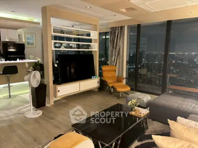 Luxurious modern living room with city view, featuring stylish furniture and open kitchen layout.