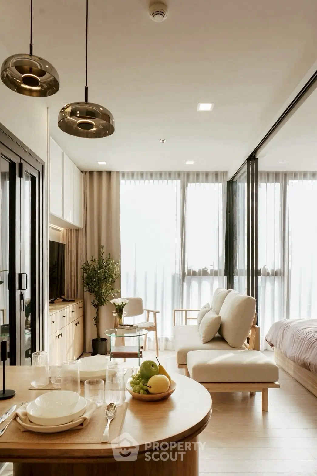 Modern open-plan living room with elegant decor and natural light