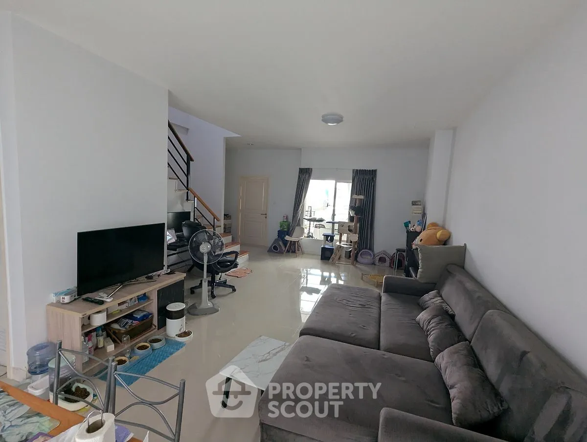 Spacious living room with modern furniture and open layout, perfect for family gatherings.