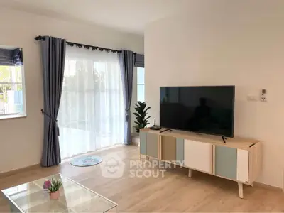 Modern living room with stylish TV stand and large window view