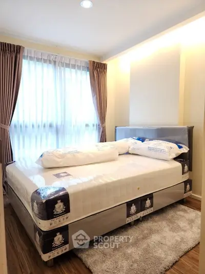 Cozy bedroom with natural light and plush carpeting in modern apartment