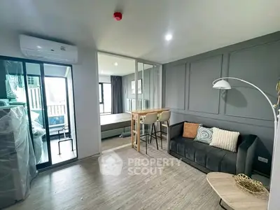Modern living room with stylish decor and open layout leading to bedroom