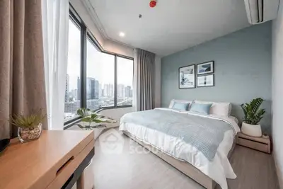 Spacious modern bedroom with large windows and city view, featuring stylish decor and cozy ambiance.