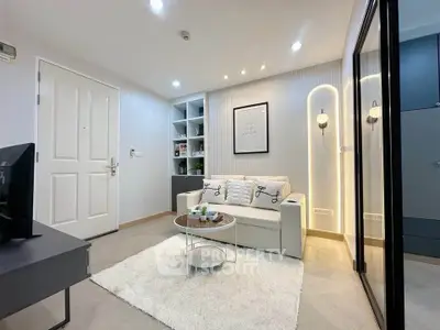 Modern living room with cozy sofa, stylish decor, and ambient lighting in a chic apartment.